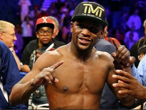Floyd Mayweather boxing champion posing for pictures
